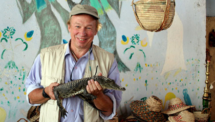 Host Richard Bangs holds a baby crocodile